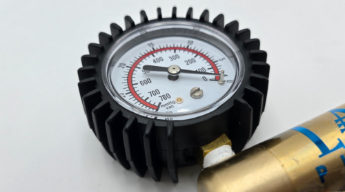 Premium rubber gauge protection cover installed on L.A. Pump brass vacuum pump gauge